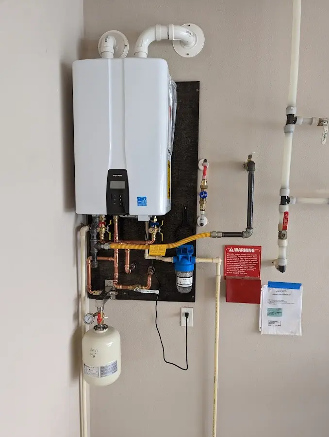 Professional plumber installing copper piping in a Lakeville home